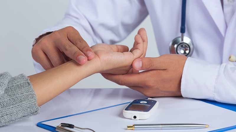 Doctor checking pulse rate for Diabetes treatment